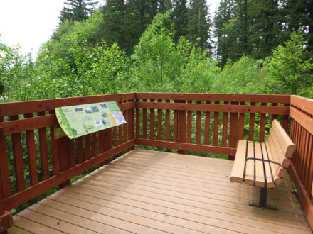 Overlook of wetlands - wood surface - bench with arms - sign with history of area and settlers